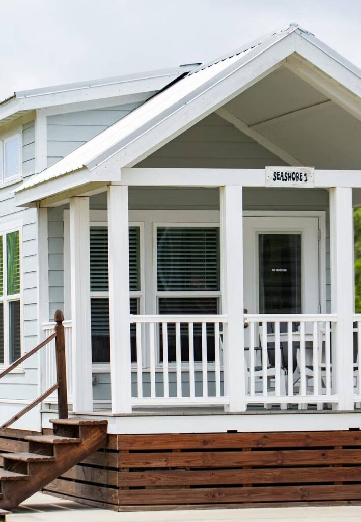 Sea Shore tiny home with covered porch at Sugar Sands RV Resort.